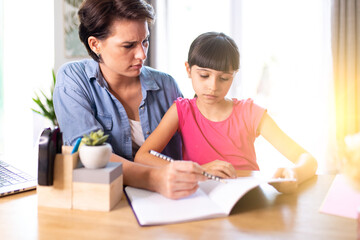 Fototapeta na wymiar mother helping daughter understand homework