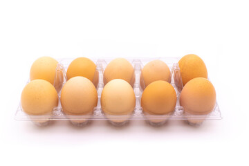 Organic eggs in transparent package, on white background. Freshly packaged organic egg packs