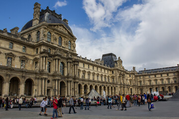 Fototapeta na wymiar View of Louvre museum the most famous visited museum in the world with tourist on weekend, Paris France