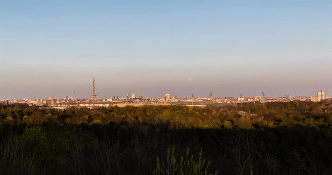 Sunset timelapse panorama of Berlin Germany skyline seen from Drachenberg with supermoon rising