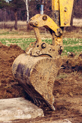 The excavator moves the concrete slabs to set the road in private territory.