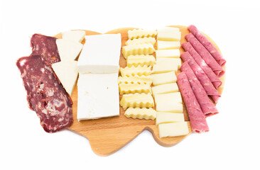 presentation of white cheese, cheddar, salami, bacon and triangular cheese on wooden board. top view.