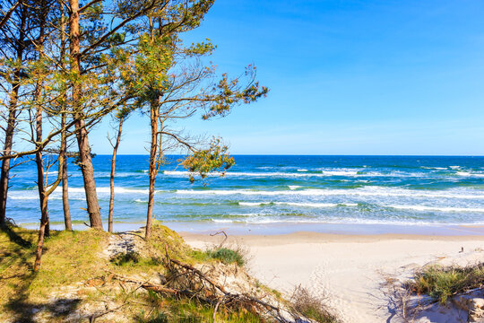 Entrance to beautiful white sand beach with blue sea near Kolobrzeg, Baltic Sea coast, Poland