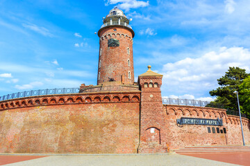 Fototapeta na wymiar Lighthouse tower in Kolobrzeg port, Baltic Sea coast, Poland