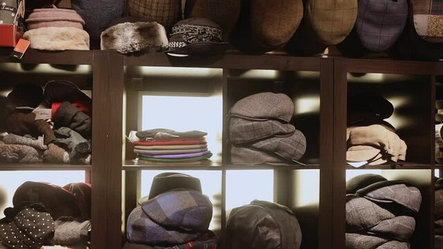 Clothing store showcase with variety of mens flat caps, womens hats and berets. High quality FullHD footage