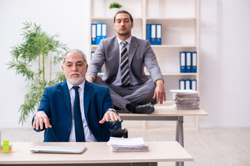 Two male employees working in the office