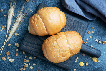 Fresh wheat bread rolls. Rolls for a hot dog or hamburger. Dark background copy space.