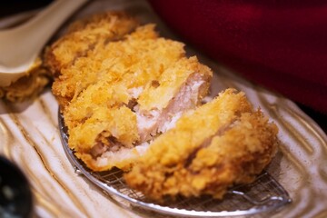 Close up of Tonkatsu panko breaded deep fried pork cutlet thai street food market