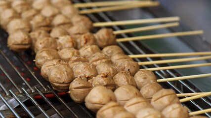 Close up of Grill Meatballs on wooden skewers thai street food market