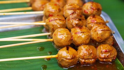 Close up of Grill Meatballs on wooden skewers thai street food market