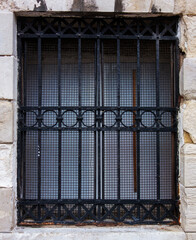 Fototapeta na wymiar Window with decorative security bars 