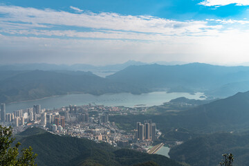 Panorama view of Shenzhen cityscape from top of Wutong Mountain on a sunny day