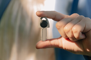 Women s hands close up hold the keys to the future apartment. The concept of a real estate transaction