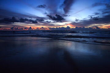 Incredible sunset on the asian coast. Holiday with family in Thailand. Evening walk along the seashore. Image with selective focus, noise effect and toning.