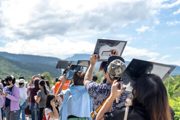 Chiang Mai, Thailand - June 21, 2020 : Partial solar eclipse, People viewing a solar eclipse via DIY telescope with indirect observation method at Princess Sirindhorn AstroPark. - obrazy, fototapety, plakaty