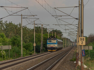 Fototapeta premium Electric blue engine and coaches on fast railway in south of Moravia