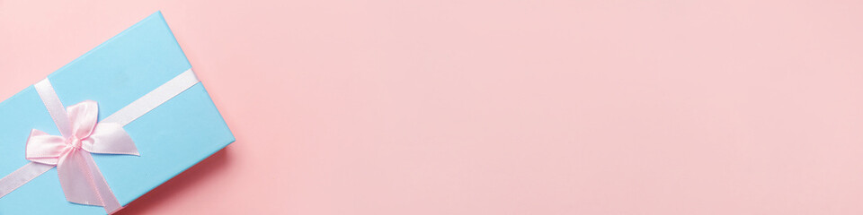 Christmas New Year birthday valentine celebration present romantic concept. Simply minimal design blue gift box isolated on pink pastel colorful background. Flat lay top view copy space, banner