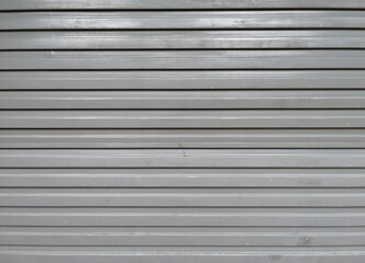 Obraz premium Perforated metal garage door texture background. Copy space.