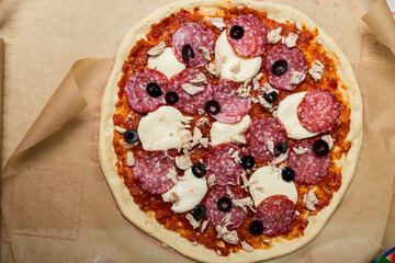 making pizza. raw dough on baking paper.