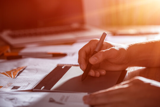 Graphic designer drawing sketches logo design.