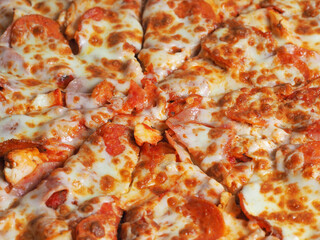 Closeup top view of pizza with ham, Perroni and cheese. Delicious Italian dish at home