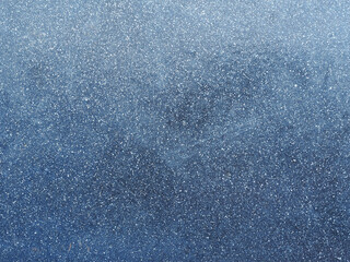 dark blue metal surface of the wall with white flecks. Metallic blue background