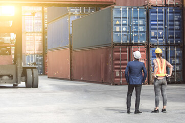 Workers standing in front of containers