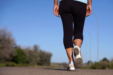 A woman walks on a road alone