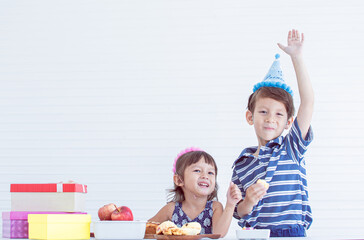 Little boy and girl celebrating birthday party