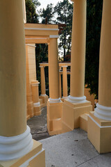 architecture and heritage concept - group of yellow columns in the park