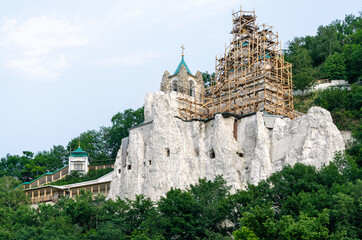 restoration of christian church on stone rock mountain in the forest