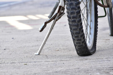 Closeup view of bicycle flat tire on pavement.