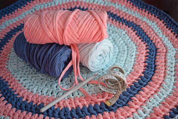 Multi-colored knitted yarn.Round handmade carpet.