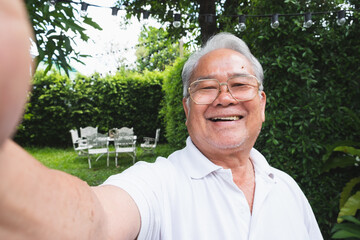 Asian senior man selfie while video call with family