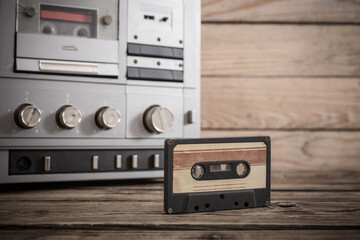 old tape recorder and cassette on  wooden background