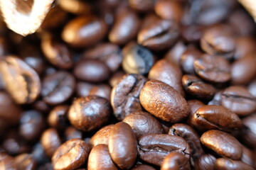 close up coffee beans and coffee cup on wood table background and texture