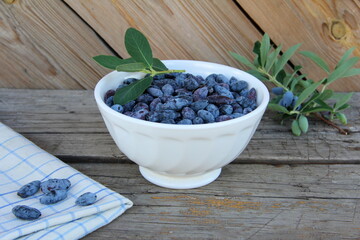 Honeysuckle berries in a vase on the table, honeysuckle, healthy berry, proper nutrition, jam,...