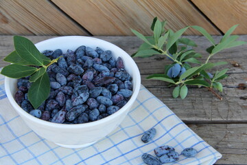 Honeysuckle berries in a vase on the table, honeysuckle, healthy berry, proper nutrition, jam, vegetarianism, ripe berry, sweet berry, blue berry.

