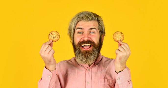 man on dieting. bearded hipster hold biscuit. full of calorie. concept of harmful food. pastry and dessert. bakery shop advertisement. homemade chocolate chip cookies