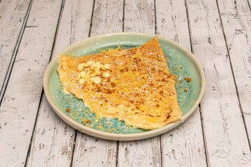 Sweet crepe dish on wooden background