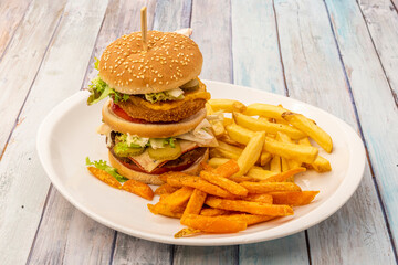 Delicious huge burger with potatoes and sweet potatoes