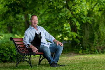 man on park bench with dog