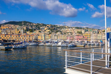 Fototapeta premium Genoa, Italy - August 18, 2019: Porto Antico di Genova or Old Port of Genoa and the cityscape in the background