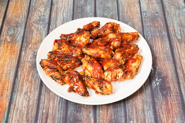 Serving of chicken wings on the wooden table