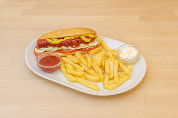 hot dog with potatoes on wooden background