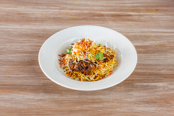 Plate of biryani rice on wooden background