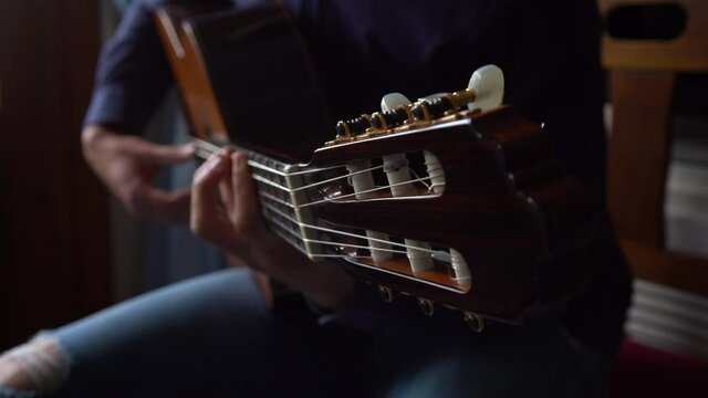 A Man Plays An Acoustic Guitar.