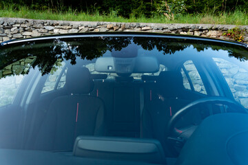 Windshield rain and light sensors position, luxury car windscreen, blue tinted glass, front view,...