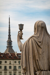 Turin, Italy - 26.05.2020: The statue of Faith in front of Church of Gran Madre di Dio with the cityscape and the top of Mole Antonelliana in the background
