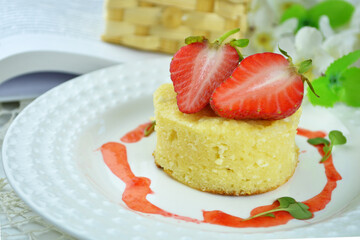 Round dessert with strawberries  on a white plate